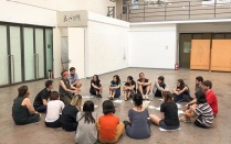 Students participate in a movement and performance workshop. 