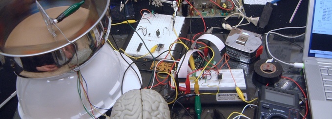 Protoboard and wiring connecting circuits to a model of a brain. 