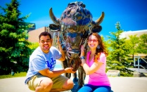 Two students with the Buffalo statue. 