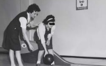 two students from the 1960s bowling. 