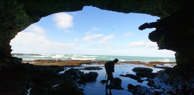 Student in oceanside cave. 