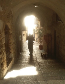 A man and child walk through old Jerusalem. 