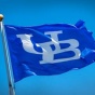 A blue UB flag flies in the wind. 
