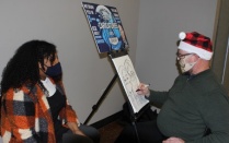Zoom image: The balloonist and caricature artists were kept busy at the holiday party. 