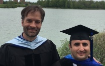 Prof. Jacob Kathman with student Muhammed Erenler at graduation. 