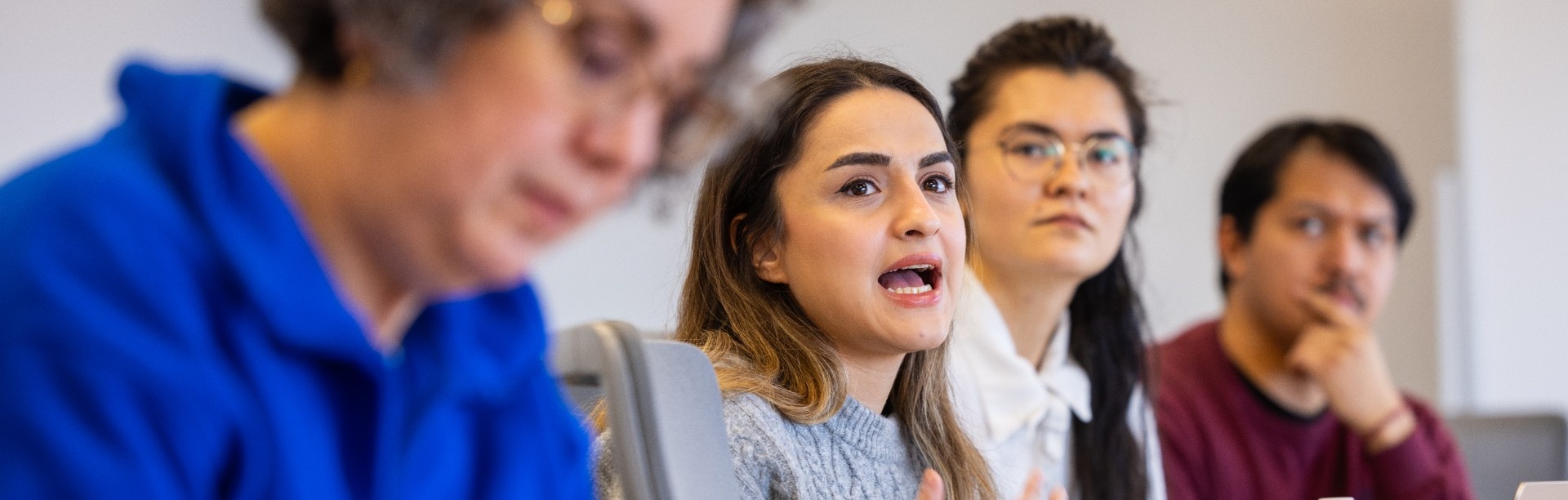 Students in a classroom talking.