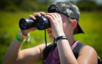 Student holding binoculars on a study abroad trip in Costa Rica. 