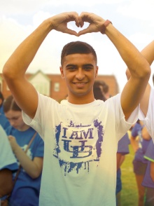A student makes "heart hands" on UB north campus. 