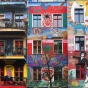 View of townhouses with colorful murals. 
