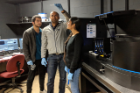 Assistant Professor Banerjee and his PhD students examines a microfluidic chip containing protein droplets. The group studies basic physical properties of intrinsically disordered proteins using optical tweezers, single-molecule fluorescence spectroscopy, and microfluidics. 