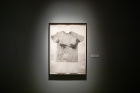 The exhibit also features a series of monoprints of T-shirts worn by volunteers as they performed physical activity. The shirts were infused with a dark substance to highlight perspiration and then put on a press to make a print.