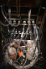 The 80-gallon fermenters are cradled by temperature-regulating units and motorized mixers connected by hoses to gas, nutrient and waste canisters.