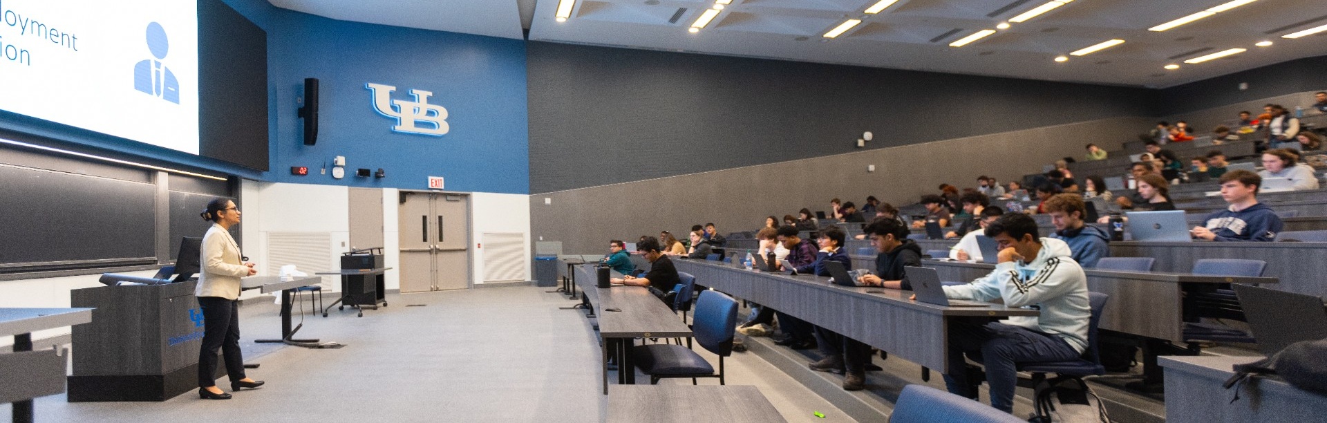 Students participate in a macroeconomics class in a large lecture hall on North Campus. 