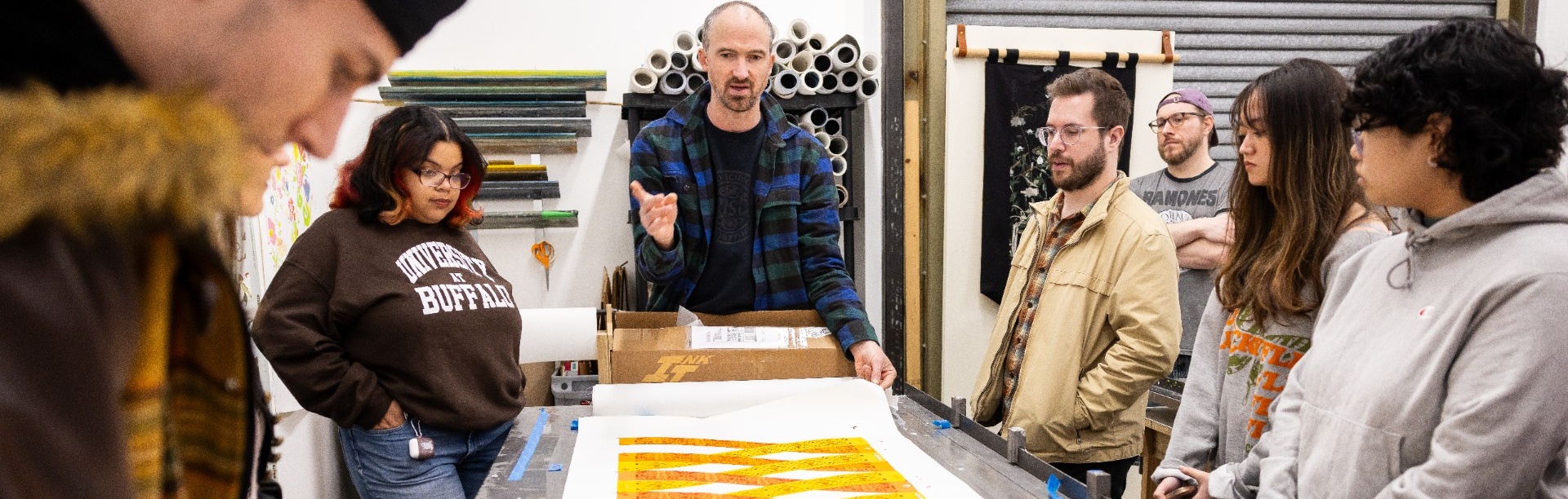 Noah Breuer hosts a field trip for undergraduate students in his screen-printing class. 