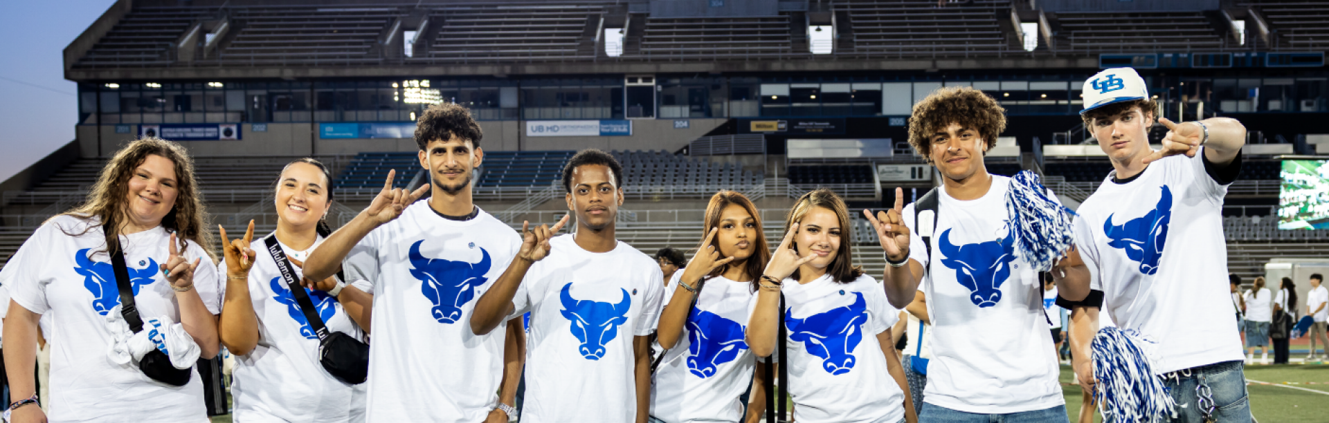 Students posing for a photo on the football field. 