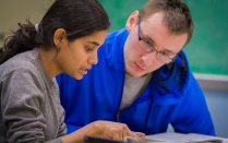 An Economics teaching assistant works with a student. 