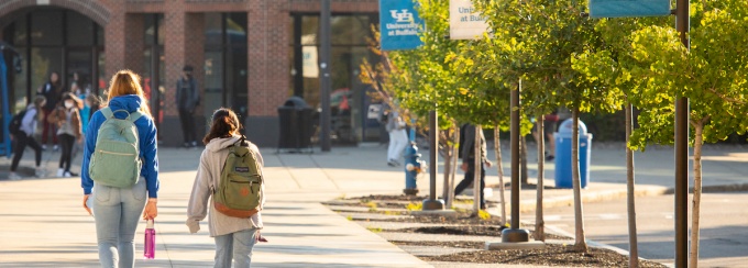 People walk outside on North Campus near Furnas Hall and the UB Commons on a fall morning in October 2021. 
