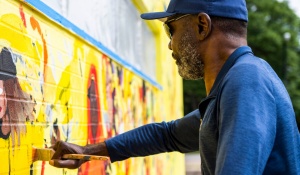 Zoom image: Professor George Hughes working on the mural. 