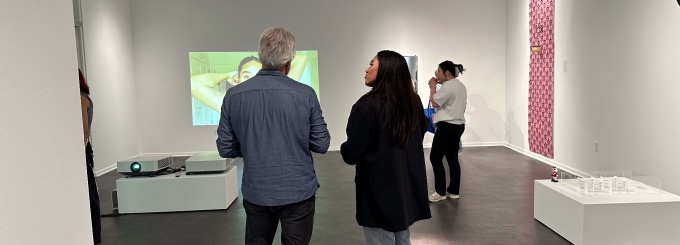 Guests visiting the BFA Senior Thesis group exhibition "Supreme", April 29th, 2024, in the Department of Art Lower Gallery, room B45 of the Center for the Arts.