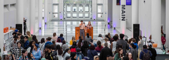 UB Center for the Arts Atrium during Spring Into Art 2024, with The Student Art Sale at the left, and Dance and Music performances stage in rear. 