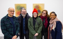 Zoom image: John Opera enjoys a visit from some UB colleagues during the opening reception. From left: Opera, Matt Kenyon, Becky Brown, Laura Chiesa and Victoria Udondian. 