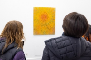Zoom image: Visitors contemplate &quot;Golden Morning,&quot; Gum bichromate process on stretched canvas, 37⅝ h x 30¼ w x 1 d inches. 