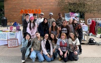 Zoom image: ART422: Entrepreneurship for Creators, class photo, with Instructor Kelly Myers-Chunco. May 1, 2025, outside the UB Student Union, on the Spine. 