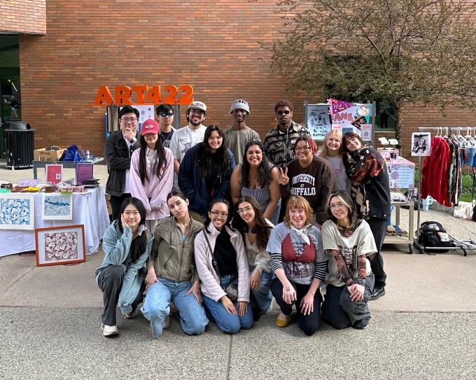 Zoom image: ART422: Entrepreneurship for Creators, class photo, with Instructor Kelly Myers-Chunco. May 1, 2025, outside the UB Student Union, on the Spine. 