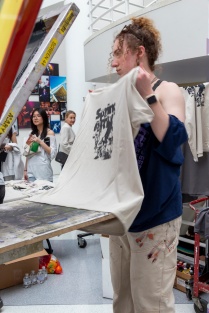 Zoom image: Emily Olearczyk screenprinting t-shirts. 