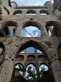 stone castle arches with no roof, making blue sky visible above. 