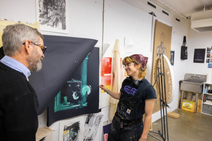 Zoom image: Gardner Astalos (right) with BFA Senior Thesis Professor Matt Kenyon (left), in a studio visit for Gardner's work Photo: Douglas Levere 
