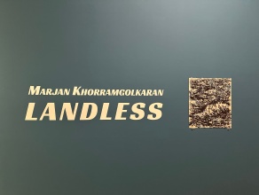 Blue wall with white text, Marjan Khorramgolkaran, Landless, and a glass plate artwork. 