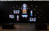 Saya Woolfalk's work "Landscape of Anticipation 2.0," 2021 at AK Northland - Difference Machines exhibition. A colorful array of led monitors and painted circles. 