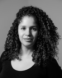 Zoom image: Christina L. De Le&oacute;n headshot wearing a black scoop nexk shirt