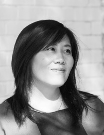 Zoom image: Imin Yeh black and white headshot in front of a white brick wall.
