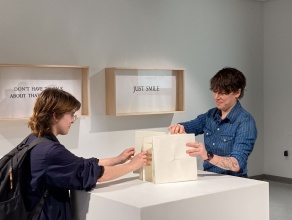 Zoom image: During the participatory performance with Artist K MacNeil, at the reception on Wednesday, 2/21/24, 5-7PM, with artist book &quot;this is not a love song&quot;. 