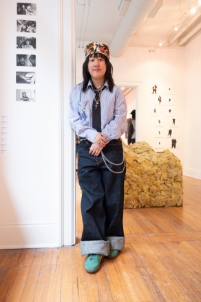 Zoom image: Charcoal drawings by Helen Lin, who stands beside.  