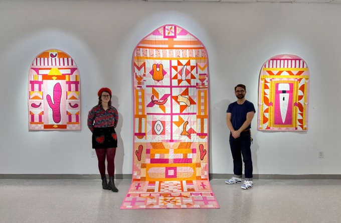 Zoom image: Left: Shayna Kiblin (artist), Right: Theo. Triandos (curator) In front of Kiblin's quilt works, all Cotton &amp; cotton batting: &quot;Rabbit&quot; (2021), &quot;Pleaser&quot; (2022), and &quot;Hitachi&quot; (2021). 