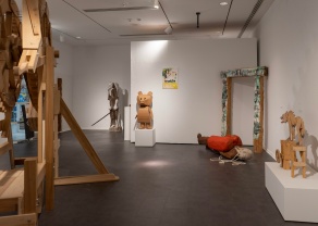 Zoom image: Fall 2023, during the exhibition &quot;Try Harder: Works from Frederick Wright Jones, An Homage to Location in Space and Time&quot; Left: Portion view of center of gallery, featuring the oversized wood work &quot;The Devil's in the Details&quot;. Back/Right: Sculptures by Jones in front of mobile wall, which was positioned parallel to the back 23'8&quot; wall, abutting the 48'6&quot; wall on the right. Image Credit: Misael Hernandez 