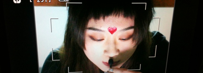 snapshot of the recording screen of a video camera with a woman's head in the frame.