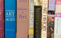 Book spines of various art history textbooks lined up on a shelf. 