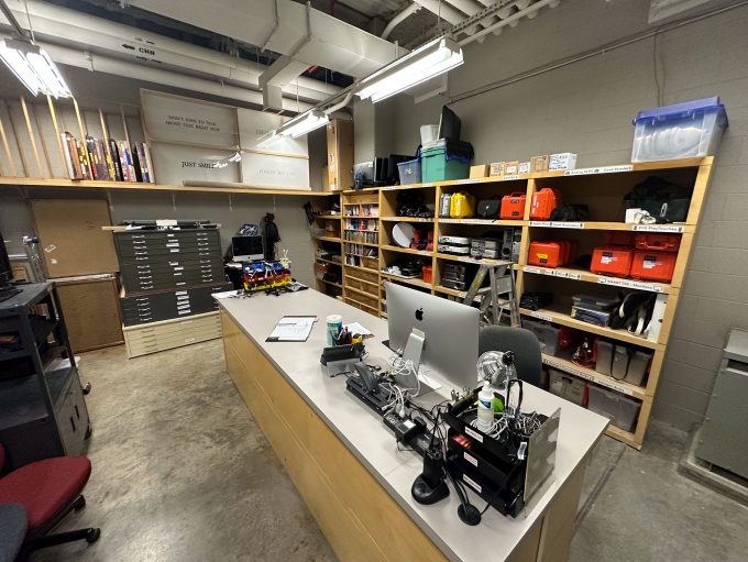 Room B41 of the Center for the Arts, lined with shelves of equipment. 