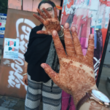 A student showing off drawings on her hand. 