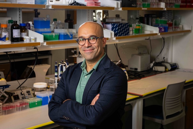 A portrait of Omer Gokcumen, with the department of biological sciences, photographed in a research lab in Hochstetter Hall in October 2024. Photographer: Meredith Forrest Kulwicki. 