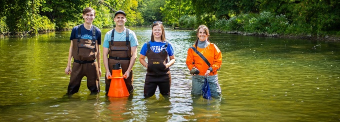 L to R: MS student Max Striedl, Research Technician Jonah Fronk, Dr. Corey Krabbenhoft, and Dr. Isabel Porto-Hannes. Their work began in July with the installation of water tanks at UB and an opportunity to collect gravid female mussels from a local creek bed. Photos: Douglas Levere. 