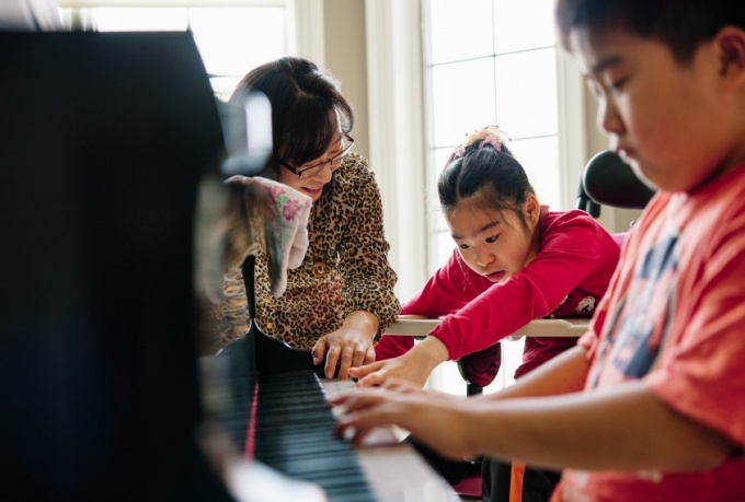 Expressing interest: Biologist Soo-Kyung Lee with her daughter Yuna and her son Joon. Yuna cannot walk or speak, but she likes stuffed animals and toys that light up or play music. Photograph by Eric Tronolone. 