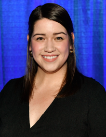 Portrait of Dr. Stipancic smiling against a blue background. 