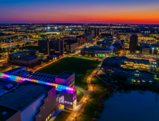 Aerial images taken at sunset of the Center for the Arts with rainbow lighting in the atrium glass to show support for UB’s LGBTQ + community.