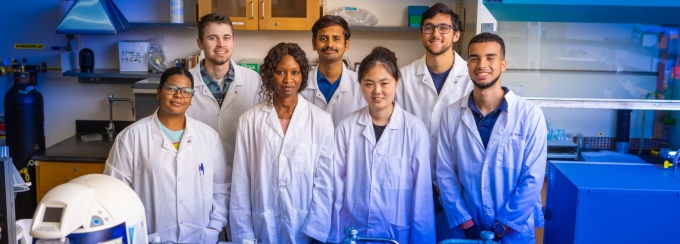 The Chemistry department hosted students through a Research Experiences for Undergraduates (REM) summer program. The group was photographed in August 2023 in a lab in the Natural Sciences Complex. Photographer: Douglas Levere. 