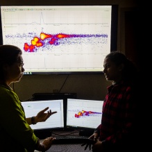 Professor Diana Aga and her PhD student looking at research data on a screen. 